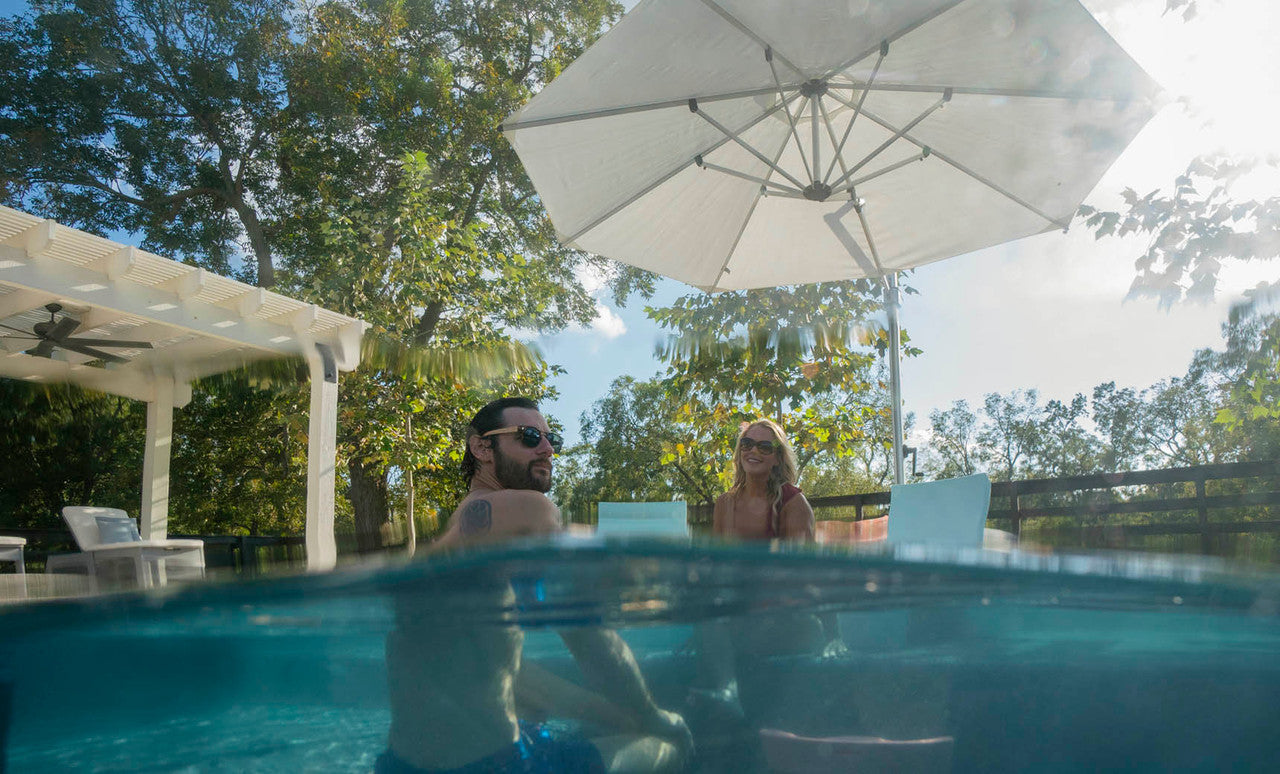 Ledge Lounger Ultra cantilever umbrella over in-pool seating