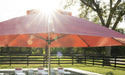 Ledge Lounger Essential pool umbrella shown in an outdoor setting, lifestyle photo 4 of 7