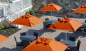 Ledge Lounger Essential pool umbrella shown in an outdoor setting, lifestyle photo 7 of 7