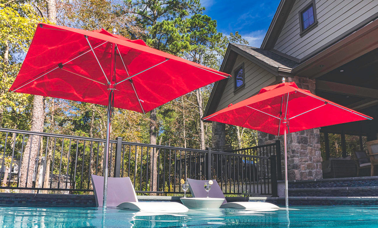 Ledge Lounger Premier pool umbrella shown in an outdoor setting, lifestyle photo 1 of 4