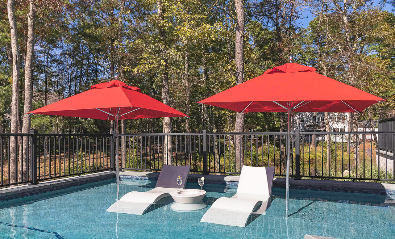 Ledge Lounger Premier pool umbrella shown in an outdoor setting, lifestyle photo 1 of 4