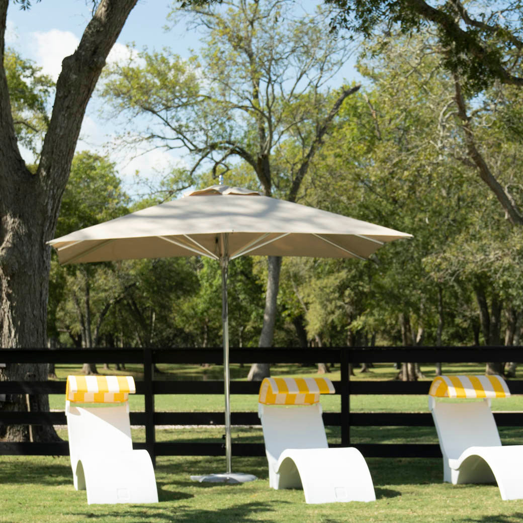 Ledge Lounger Premier pool umbrella shown in an outdoor setting, lifestyle photo 2 of 4