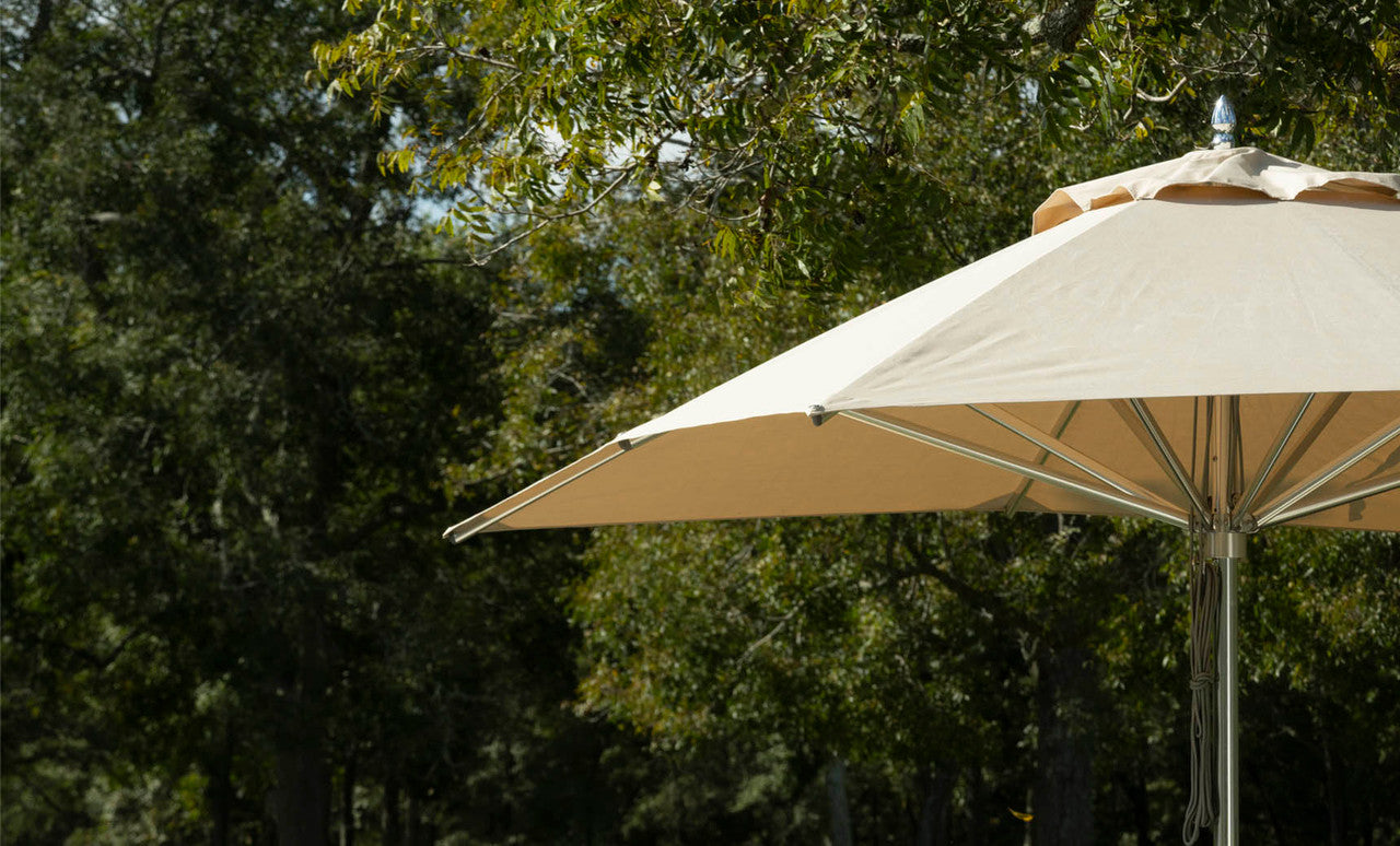 Ledge Lounger Premier pool umbrella shown in an outdoor setting, lifestyle photo 2 of 4