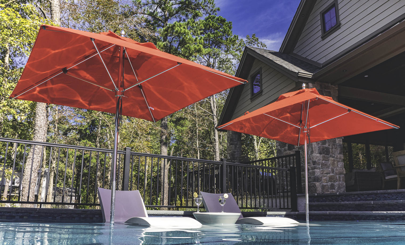 Ledge Lounger Premier pool umbrella shown in an outdoor setting, lifestyle photo 4 of 4